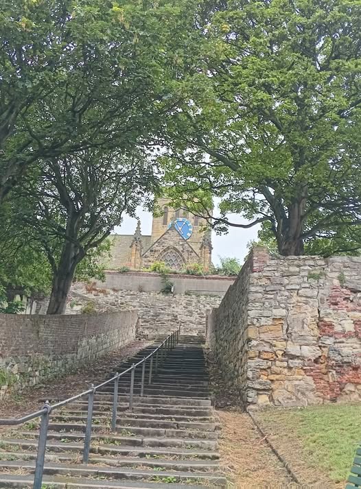 A long staircase leads up to St Mary's Church from close to the sea front. There is a banister going all the way up the middle. 